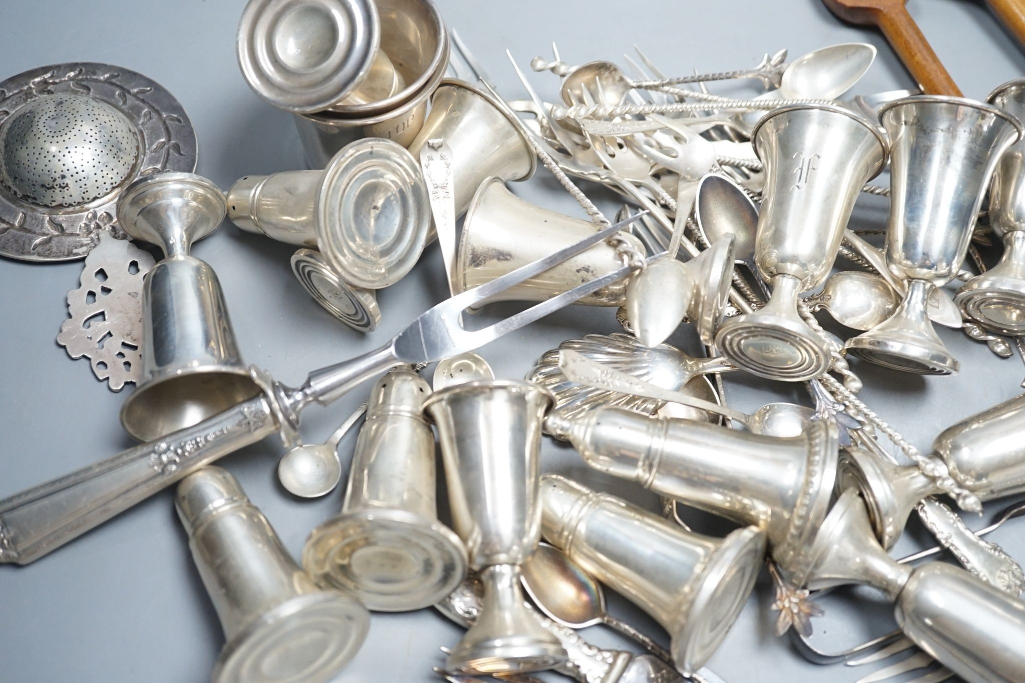 A quantity of American sterling items including four beakers, twelve assorted small goblets(weighted?), six assorted condiments(weighted?) and group of miscellaneous flatware